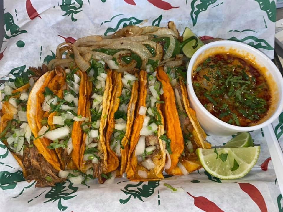 Quesabirria tacos with a cup of consomé