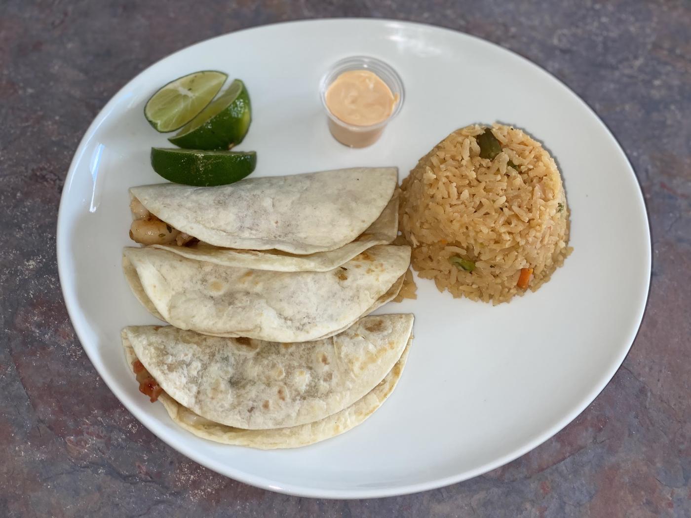 Shrimp tacos with Mexican rice and lime